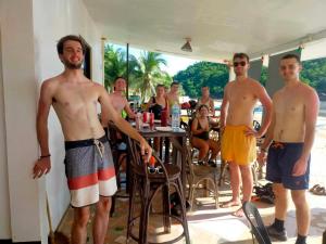 a group of men standing in a room at the beach at Dandal Bay view in El Nido