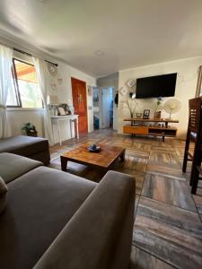 a living room with a couch and a coffee table at Mels House Batuco in El Cerrillo