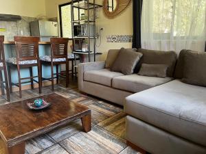 a living room with a couch and a table at Mels House Batuco in El Cerrillo