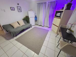 a living room with a couch and purple lighting at Beach Hub 7 Mins to Airport in Carolina
