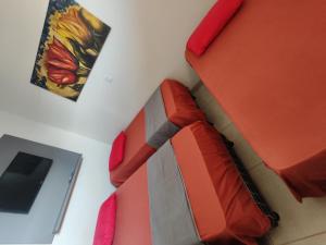 a room with a couch with a knife on it at Quarto Triplo Comercial - Queen's Hotel in Formosa