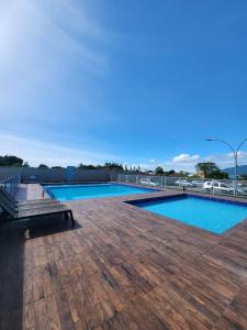 a swimming pool on the roof of a building at Praia e Cambirela in Palhoça
