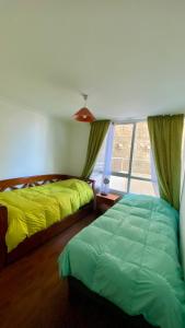 a bedroom with two beds and a window at Borde Costero in Valparaíso