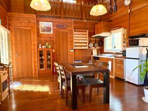 a kitchen with a table and chairs in a room at beau lac biwako annex in Takashima