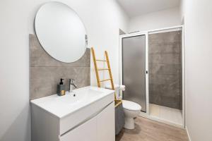 a bathroom with a white sink and a mirror at Sol Blessing by GALMI in Ponta do Sol +23 photos