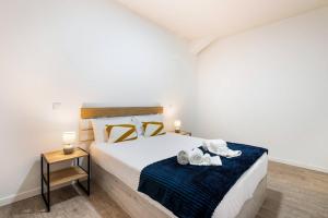 a bedroom with a bed with shoes on it at Sol Blessing by GALMI in Ponta do Sol