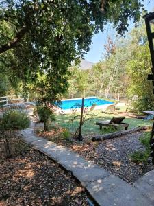 a swimming pool with a picnic table and a bench at Casa Olmué in Olmué