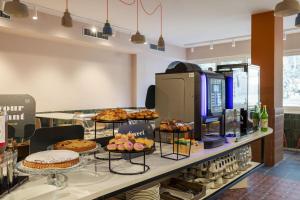 a bakery with various pastries and cakes on display at B&B HOTEL Como Baradello in Como