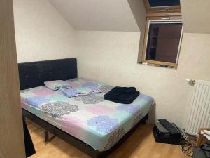 a small bed in a room with a window at Lux 3 in Orléans
