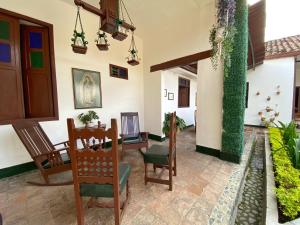 a dining room with a table and chairs at Hotel Casa Antigua Buga in Buga