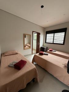 a bedroom with two beds and a window at Pousada Cobogó - MotoWeek, ANP in Brasília +98 photos