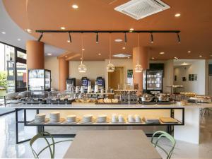 a restaurant with a buffet of food on display at B&B HOTEL Latina in Latina