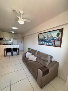 a living room with a couch and a table at Lindo APTO na Ponta Verde in Maceió