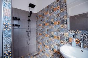 a bathroom with a shower and a sink at Olas Surf Camp in Imsouane