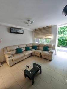 a living room with a couch and a coffee table at Casa de Verano Málaga Confort Sol y Piscina in Ricaurte