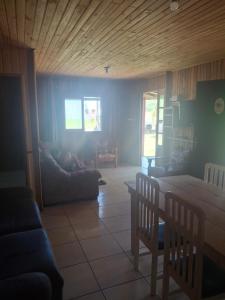 a living room with a table and a couch at Casa da praia sulmar in Balneário Gaivotas