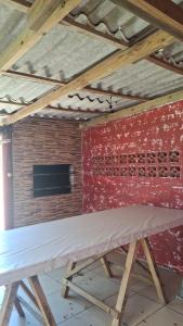 a table in a room with a brick wall at Casa da praia sulmar in Balneário Gaivotas