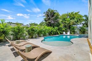 a swimming pool with two lounge chairs next to a resort at Waldemere's Wonderland in Sarasota
