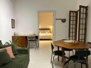 a living room with a couch and a table and a bed at The Hidden Mint - Valletta in Valletta