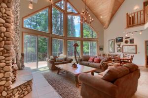 a living room filled with furniture and a large window at Rivercrest Lodge with Hot Tub-Pool Table-Firepit in North Wawona +42 photos