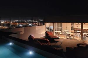 a living room with a view of a city at night at Condomínio Residencial - Hype 017 | by Housi in Sao Jose do Rio Preto