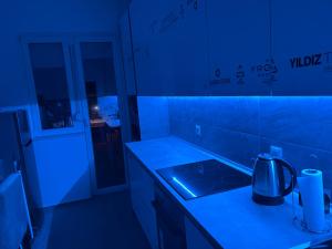 a kitchen with a blue light on a counter at Capital Gate Guest House in Skopje +75 photos