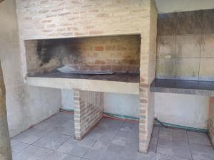 a brick oven in a kitchen with a brick wall at Cabaña don Cencio in San Pedro