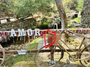 a bike parked next to a bench with a sign at Moinho de Brião in Montalegre +35 photos