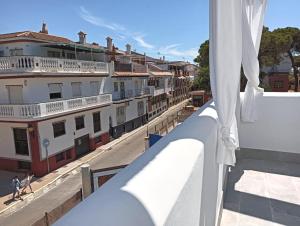 a view of a city from the balcony of a building at Villas con piscina en Punta Umbría by Villamya in Punta Umbría