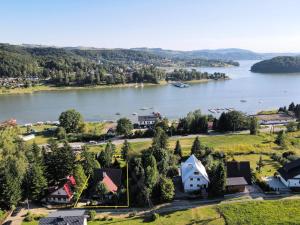 an aerial view of a village on a lake at Całoroczny dom nad Jeziorem Rożnowskim in Gródek Nad Dunajcem