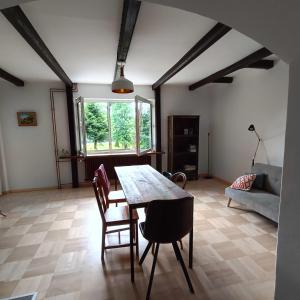 a living room with a table and chairs and a couch at Całoroczny dom nad Jeziorem Rożnowskim in Gródek Nad Dunajcem