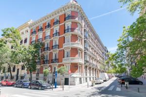 a large red brick building on a city street at AYZ Juan de Mena - Auto check-in property in Madrid