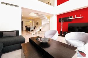 a living room with a couch and a table at St Isidro Suites Corporate Housing SPA & Wellness Center in Mexico City
