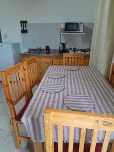 a kitchen with a table with a striped table cloth on it at Bienvenidos viajeros in Chajarí