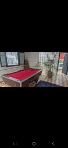 a ping pong table in a living room with avertisementvertisementosateosateosate at sharing is caring in Tamraght Ouzdar