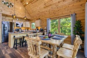 a kitchen and dining room with a table and chairs at Ridge Hollow Retreat - Hot Tub, Fire Pit, Dogs in Gatlinburg