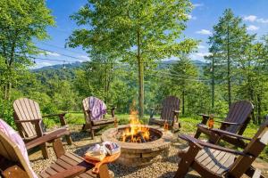 a fire pit in a yard with chairs and trees at Ridge Hollow Retreat - Hot Tub, Fire Pit, Dogs in Gatlinburg +32 photos