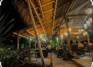 a restaurant with people sitting at tables in a building at NO name bangalow in Ko Lanta Yai