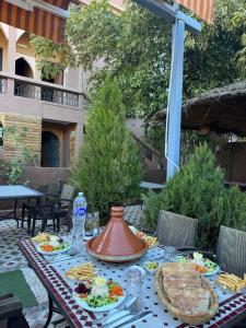 a table with food on top of a patio at Dar Diafa Kaltom in Ouzoud