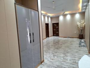 a hallway with a large glass door in a building at Pelican VVIP Villa in Wa +14 photos