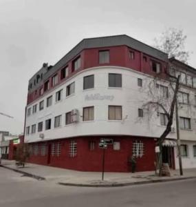 a red and white building on the corner of a street at HOTEL Y MOTEL SAVOY - Santiago in Santiago