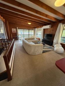 a living room with a couch and a tv at Terrigal Cottage in Terrigal