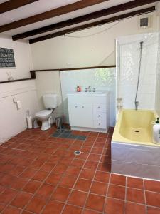 a bathroom with a tub and a sink and a toilet at Terrigal Cottage in Terrigal +18 photos