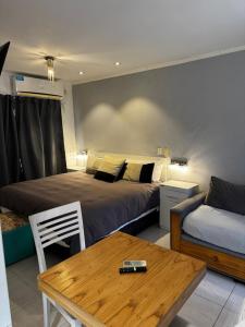 a hotel room with two beds and a table and a table sidx sidx at DINASTIE PALACE in Chajarí