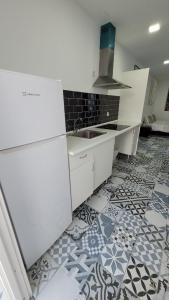 a white kitchen with a sink and a tile floor at AYZ Silvela - Auto check-in property in Málaga +44 photos