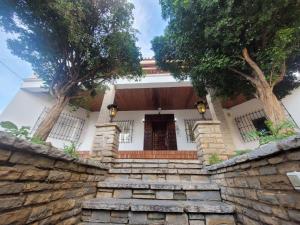 a house with a stone wall and a stone staircase at AYZ Silvela - Auto check-in property in Málaga
