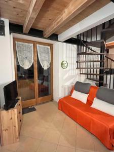 a living room with a bed and a tv at BORMIO Alpine Suite in Valdidentro