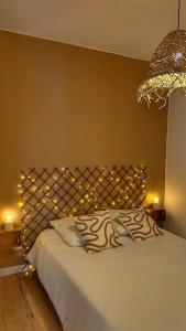 a bedroom with a bed with lights on it at Casa Sole in Saint-Chamond