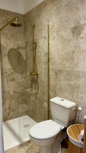 a bathroom with a toilet and a glass shower at Casa Sole in Saint-Chamond +4 photos