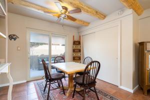 a dining room with a table and chairs and a ceiling fan at Casita De Alces in Santa Fe +9 photos